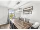 Bright dining room with a wooden table, stylish chairs, and natural light from the window at 3582 Fieldhurst Ln, Plainfield, IN 46168