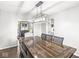 Elegant dining room features a large wooden table and modern chandelier lighting at 3582 Fieldhurst Ln, Plainfield, IN 46168