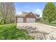 Exterior view with brick accents and a spacious three-car driveway, offering ample parking at 3582 Fieldhurst Ln, Plainfield, IN 46168