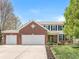 Charming two-story brick home featuring a three-car garage and well-maintained landscaping, perfect for Gathering living at 3582 Fieldhurst Ln, Plainfield, IN 46168