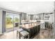 Modern kitchen featuring an island with a butcher block countertop, stainless steel appliances, and backyard access at 3582 Fieldhurst Ln, Plainfield, IN 46168