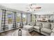 Open-concept living room features a large sectional sofa and modern finishes with a kitchen view at 3582 Fieldhurst Ln, Plainfield, IN 46168