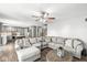 Spacious living room with a large sectional sofa, ceiling fan, and wood-look flooring at 3582 Fieldhurst Ln, Plainfield, IN 46168