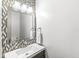 Stylish powder room with a modern mosaic backsplash and sleek vanity at 3582 Fieldhurst Ln, Plainfield, IN 46168