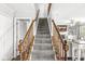 Carpeted staircase with wooden banisters leads to the upper level of the home at 3582 Fieldhurst Ln, Plainfield, IN 46168