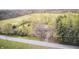 Aerial view of property surrounded by lush greenery, fields, and a paved road at 3913 E Cr 600 S, Clayton, IN 46118