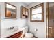 This bathroom features a vanity with granite countertop, wooden cabinets, and a window providing natural light at 3913 E Cr 600 S, Clayton, IN 46118