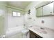 A clean bathroom featuring a tub/shower, toilet, white tiled walls, and marble-look sink at 3913 E Cr 600 S, Clayton, IN 46118