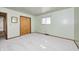 A cozy bedroom boasts soft, neutral walls, wood trim, white carpet, and a window with natural light at 3913 E Cr 600 S, Clayton, IN 46118