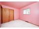 A bright pink bedroom includes a light window, closet with wood doors, and plush white carpet at 3913 E Cr 600 S, Clayton, IN 46118