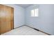Cozy bedroom with neutral carpet and light blue painted walls and trim with a closet and window at 3913 E Cr 600 S, Clayton, IN 46118