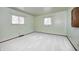 Bedroom features soft, neutral walls, white carpet, wood trim, and two windows with natural light at 3913 E Cr 600 S, Clayton, IN 46118