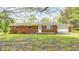 Charming brick ranch-style home with an attached garage and a yard with flowering plants at 3913 E Cr 600 S, Clayton, IN 46118