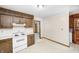 Well-lit kitchen with white appliances, wooden cabinets, and a view into the adjacent room at 3913 E Cr 600 S, Clayton, IN 46118