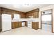 Functional kitchen with wooden cabinetry, white appliances, and a window for natural light at 3913 E Cr 600 S, Clayton, IN 46118