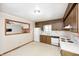 Practical kitchen with wooden cabinets, white appliances, and ample countertop space for meal preparation at 3913 E Cr 600 S, Clayton, IN 46118