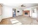 Bright living room featuring a fireplace, ceiling fan, and multiple doorways for easy access at 3913 E Cr 600 S, Clayton, IN 46118