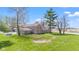 Aerial view of a two-story brick home with mature trees and a spacious lawn in a rural setting at 4155 S State Rd 39, Lebanon, IN 46052