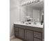 Bathroom with double vanity, large mirror with modern lighting and flower arrangement at 4155 S State Rd 39, Lebanon, IN 46052