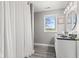 Modern bathroom featuring neutral colors, a stand up shower with a white curtain, and a view to the outside at 4155 S State Rd 39, Lebanon, IN 46052