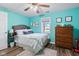 Bright bedroom with a comfortable bed, wood floors, natural light and refreshing turquoise walls at 4155 S State Rd 39, Lebanon, IN 46052