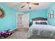 Cheerful bedroom with bright teal walls, decorative accents, and modern ceiling fan at 4155 S State Rd 39, Lebanon, IN 46052