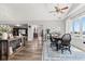 Open dining room with modern decor, wood floors, gray walls, and view into the living room at 4155 S State Rd 39, Lebanon, IN 46052