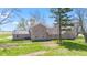 Back exterior showing a brick home with manicured lawn at 4155 S State Rd 39, Lebanon, IN 46052