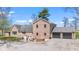 Expansive home with a brick exterior, attached two-car garage, and a spacious gravel driveway at 4155 S State Rd 39, Lebanon, IN 46052