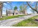Brick home with an attached garage, landscaping, and mature trees in a country setting at 4155 S State Rd 39, Lebanon, IN 46052