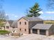 Brick home with an outdoor seating area and an attached two-car garage in a rural setting at 4155 S State Rd 39, Lebanon, IN 46052