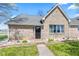 Charming brick home featuring a black front door, manicured landscaping, and a walkway at 4155 S State Rd 39, Lebanon, IN 46052