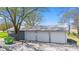 Spacious three-car garage with metal roof and ample parking space on a sunny day at 4155 S State Rd 39, Lebanon, IN 46052