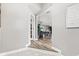 Hallway view into the house featuring wood floors and gray walls and view into the living room at 4155 S State Rd 39, Lebanon, IN 46052