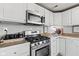 Bright kitchen featuring white cabinets, stainless appliances, and a gas range at 4155 S State Rd 39, Lebanon, IN 46052