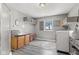 Spacious laundry room features grey vinyl floors, modern washer and dryer, ample cabinet and basket storage at 4155 S State Rd 39, Lebanon, IN 46052