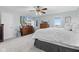 Bright main bedroom features carpet, a ceiling fan, a large window, and a mounted television at 4155 S State Rd 39, Lebanon, IN 46052