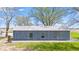 Exterior view of an outbuilding featuring gray siding, a metal roof, and three windows at 4155 S State Rd 39, Lebanon, IN 46052