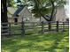 Beautiful brick home with a well-maintained lawn and charming wooden fence, perfect for a Gathering at 4155 S State Rd 39, Lebanon, IN 46052