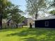 Charming property featuring a brick home, a wooden fence, and a modern-looking outbuilding on a well-manicured lawn at 4155 S State Rd 39, Lebanon, IN 46052