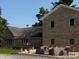 Brick home features a patio with covered outdoor furniture and potted plants at 4155 S State Rd 39, Lebanon, IN 46052