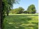 Expansive front yard with lush lawn, mature trees, and a charming wooden fence at 4155 S State Rd 39, Lebanon, IN 46052