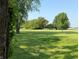 Expansive front yard with lush lawn, mature trees, and a charming wooden fence at 4155 S State Rd 39, Lebanon, IN 46052