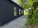 Side view of a modern dark-colored outbuilding with three windows at 4155 S State Rd 39, Lebanon, IN 46052