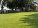 Expansive lush green lawn with mature trees and a charming wooden fence in the background at 4155 S State Rd 39, Lebanon, IN 46052