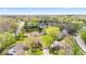 Aerial view of a neighborhood highlighting lush greenery and pond, plus home with driveway and landscaping at 4322 Matrea More Ct, Indianapolis, IN 46254