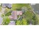 Bird's eye view of home showing backyard deck, patio, and lush landscaping near pond at 4322 Matrea More Ct, Indianapolis, IN 46254