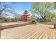 Spacious wooden back deck with grill and outdoor seating area overlooking landscaped yard at 4322 Matrea More Ct, Indianapolis, IN 46254