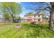 Large backyard with a lawn, a deck with an umbrella, and a trampoline at 4322 Matrea More Ct, Indianapolis, IN 46254