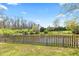Fenced backyard overlooking a pond, with trees and landscaping at 4322 Matrea More Ct, Indianapolis, IN 46254
